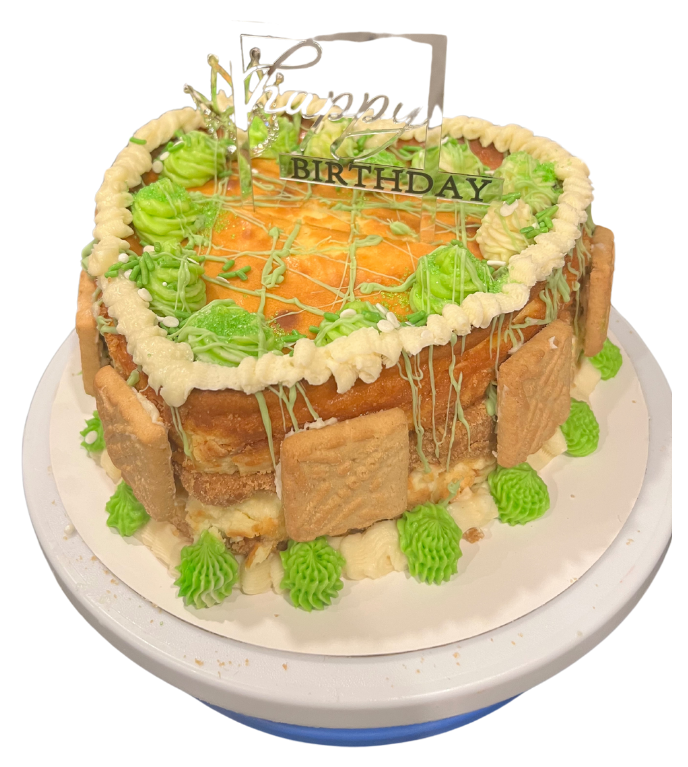 Heart shaped orange and green happy birthday cake